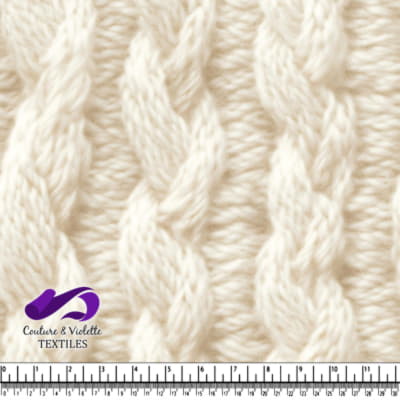Close up of cream-colored thick cable knit fabric texture